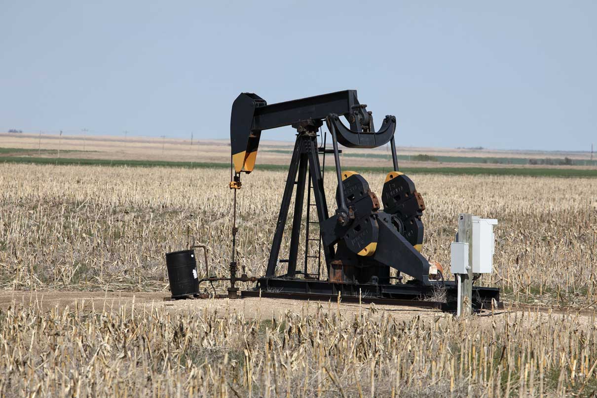 Oil Pump Working In Field In Rural Kansas